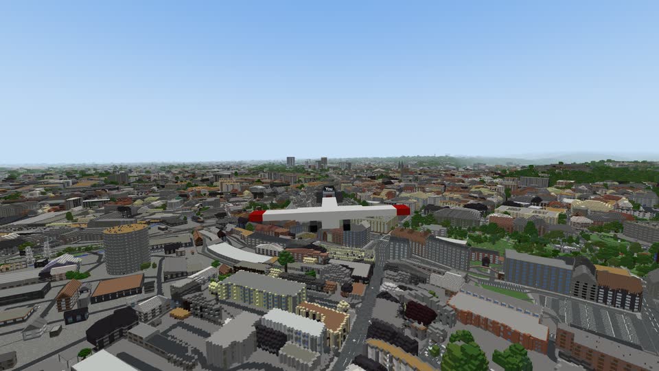 A small plane flying over the roofs of Brno